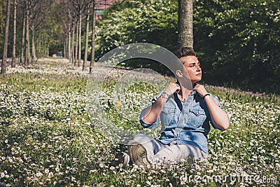 Short hair girl sitting in the grass Stock Photo