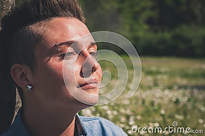 Short hair girl sitting in the grass Stock Photo