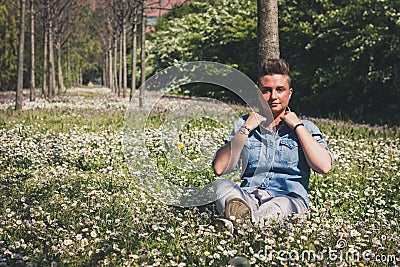 Short hair girl sitting in the grass Stock Photo