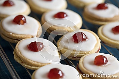 Shortbread biscuits with white icing and a cherry Stock Photo