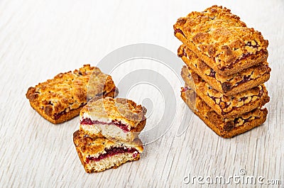 Shortbread cookies with filling from jam in stack, broken cookie on table Stock Photo