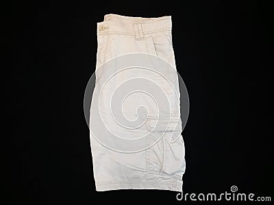 Shorts beige, lateral side, on black background Stock Photo