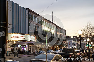 A shot along Broughton Street lined with restaurants, shops, black light posts, bare trees and people standing with cars Editorial Stock Photo