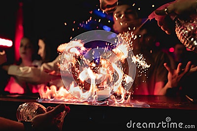 Shot b52 with a beautiful serve. Fire, sparks of flame. Night club, bar Editorial Stock Photo