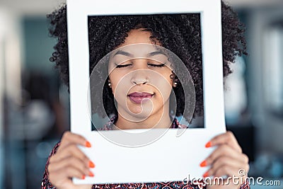 Beautiful afro business woman holding hands frame while posing to camera to snapshot in the office at home Stock Photo