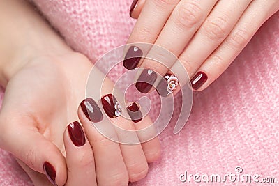 Shot beautiful manicure with flowers on female fingers. Nails design. Close-up Stock Photo