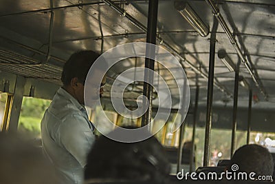 Bus conductor on duty in kerala Editorial Stock Photo