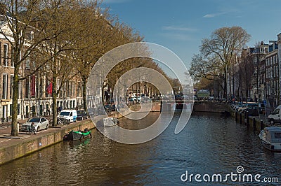 A shot of the canal in Amsterdam, Netherlands, from a bridge in the city Editorial Stock Photo