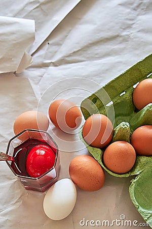 preparation for the Easter holiday, coloring eggs at home, tissue with spoons Stock Photo