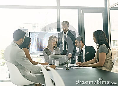 Presenting ideas to the team. Shot of corporate businesspeople meeting in the boardroom. Stock Photo