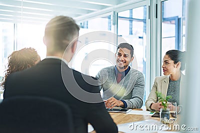 Success is the product of teamwork. Shot of corporate colleagues working together in their office. Stock Photo