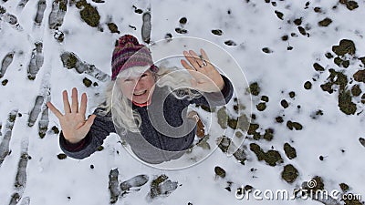 Shot with a drone. A woman waves in the direction of the sky Stock Photo