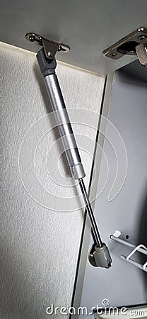 Shot of the gas strut for kitchen cabinet. Interior Stock Photo