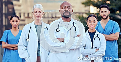 Were serious about our work. Shot of a group of doctors standing with their arms crossed in the city. Stock Photo