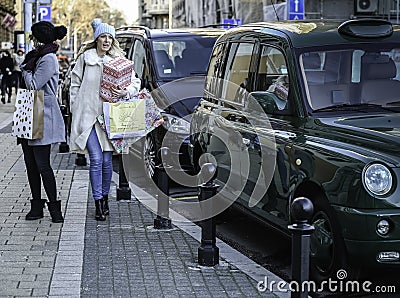 Shot of happy girls walking on the street after shopping Editorial Stock Photo