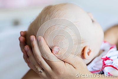 Shot of happy mother holding her baby girl. Summer vacation Stock Photo