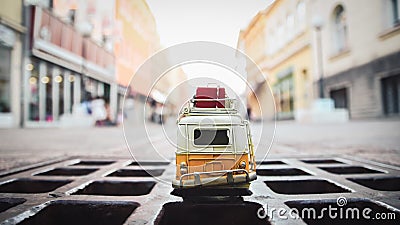 Shot of a little car toy on the road - the concept of traveling by Stock Photo