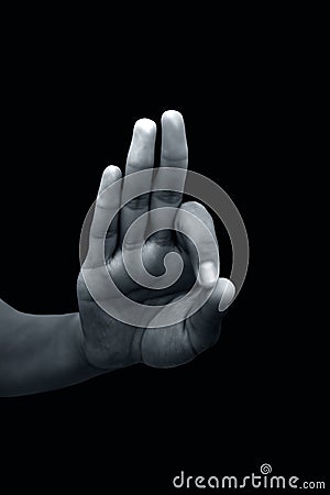 Shot of a male hand showing Gyan mudra isolated on black background. Stock Photo