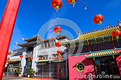 A shot of a market place with colorful buildings with Chinese architecture with several bright red Chinese Tomato Light lanterns Editorial Stock Photo