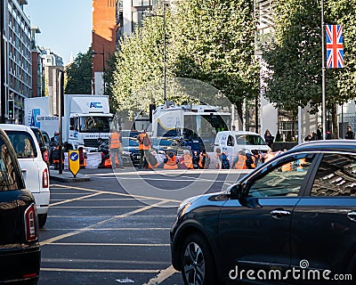 Shot of oil activists blocked the junction of Knightsbridge and Brompton Road in the morning, London Editorial Stock Photo