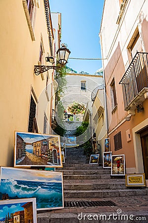 Shot of paintings on street stairs with a blue sky in the background, Taormina, Sicily, Italy Editorial Stock Photo