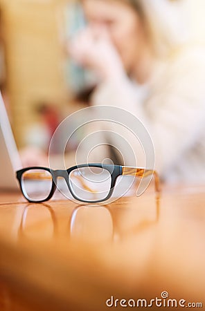 Your vision should be as clear as your future. Shot of a pair of glasses on a table indoors. Stock Photo