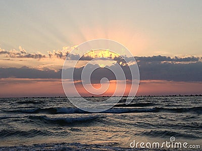 Shot of pink sunrise and scenic sscape, bright sun shining behind the clouds Stock Photo