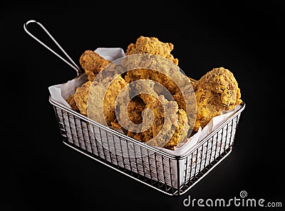 Shot of a plate full of fried chicken drumsticks on a black background Stock Photo