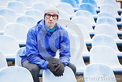 Shot of professional athlete looking at camera sitting. Stock Photo