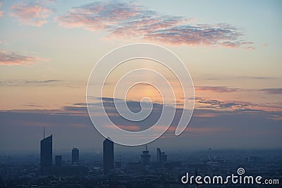 Shot of a rising sun with purple clouds and Lyon cityscape silhouettes in the background Editorial Stock Photo