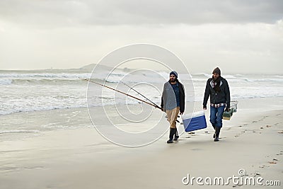 Heading off for a days fishing. Shot of a two friends fishing on an early overcast morning. Stock Photo