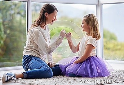 This promise will never be broken. Shot of a young mother and daughter making a pinky promise at home. Stock Photo