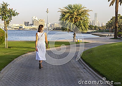 Shot of the young woman walking in the park. Outdoors Editorial Stock Photo