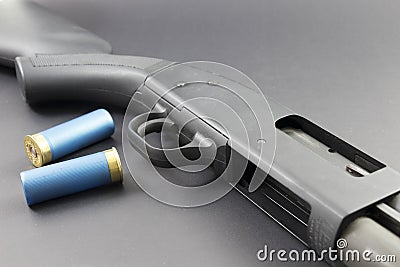 A Shotgun with Blue shotgun shells Stock Photo