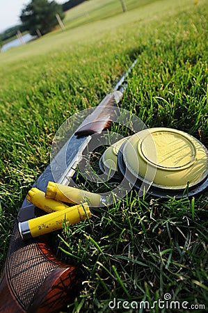 Shotgun, shells, and clay pigeons Stock Photo