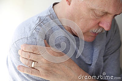 Shoulder pain in a senior man Stock Photo