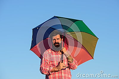 Shoulder portrait of gay man, homosexual male holding rainbow umbrella, colored in rainbow colors. LGBT movement, gay Stock Photo