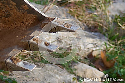 Shovel of the digging machine in the foreground of the photograph. Stock Photo