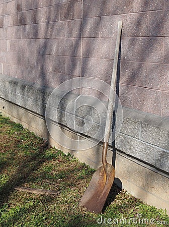 The shovel is leaning against the building. Stock Photo