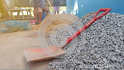 Shovel placed used for scoop stone and sand in construction work,Stone and sand material for construction work Stock Photo