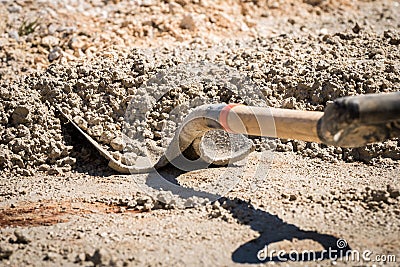 Shovel/Spade being used to mix wet cement Stock Photo