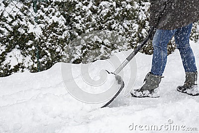 Shoveling snow on pavement Stock Photo