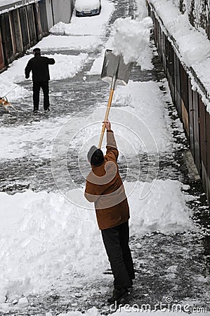 Shoveling snow upwards Stock Photo