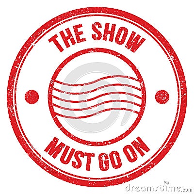 THE SHOW MUST GO ON text on red round postal stamp sign Stock Photo