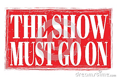 THE SHOW MUST GO ON, words on red grungy stamp sign Stock Photo