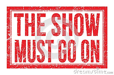 THE SHOW MUST GO ON, words on red rectangle stamp sign Stock Photo