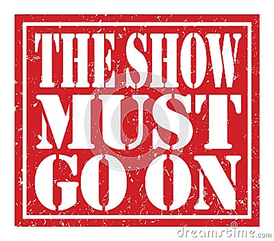 THE SHOW MUST GO ON, text written on red stamp sign Stock Photo