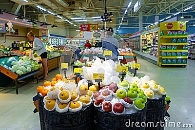 Showcase with apples of different varieties at the supermarket Editorial Stock Photo