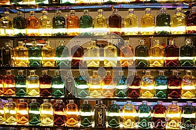 showcase bottles glass perfume glitter shine light decor multicolors Stock Photo