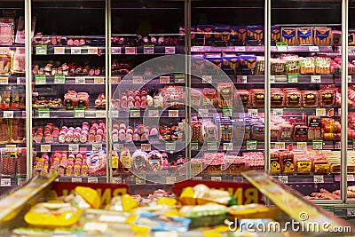 Showcase with a large assortment of sausages in the supermarket. Moscow, Russia, 01-01-2021 Editorial Stock Photo